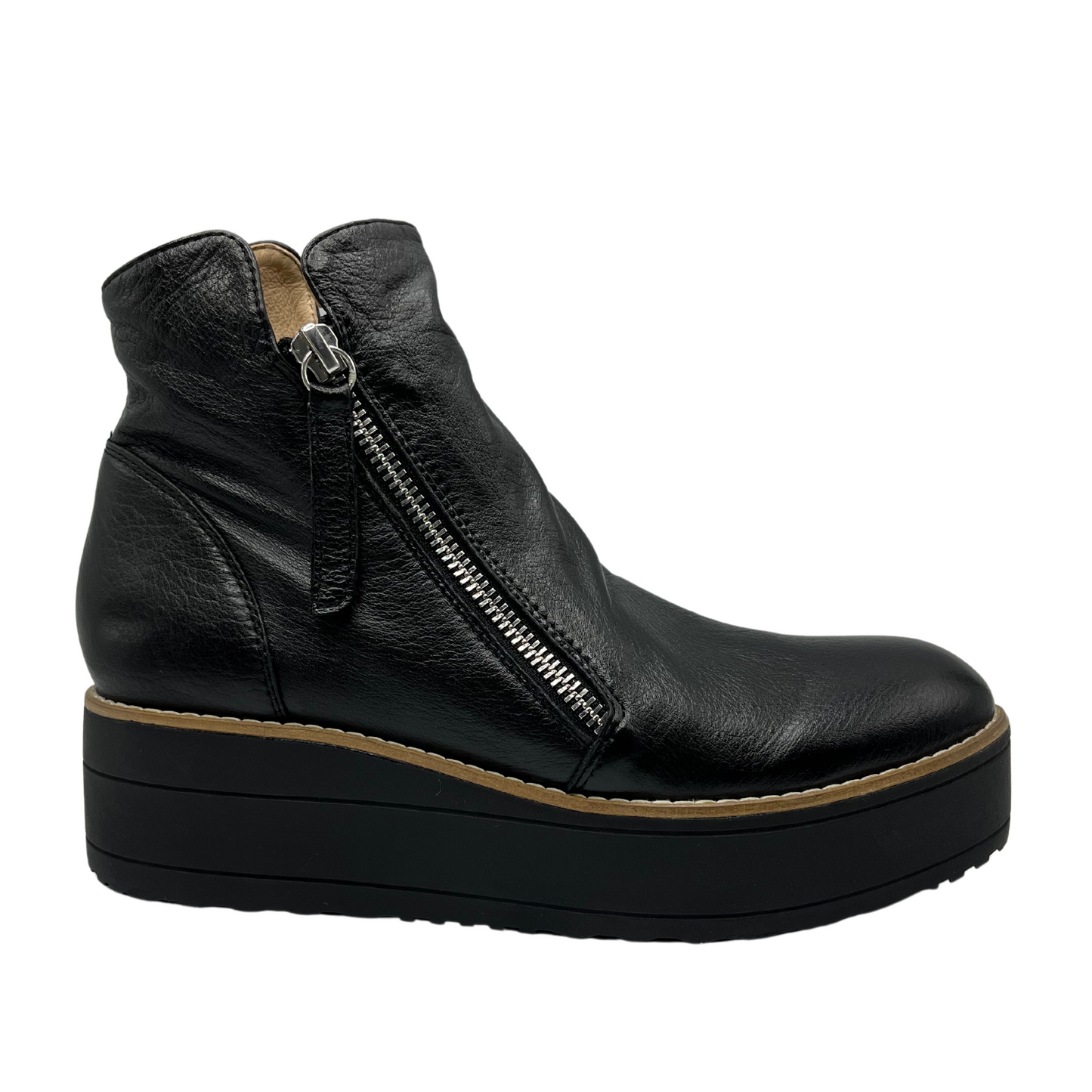 Right facing view of black leather short boot with black platform sole and double side zipper closures