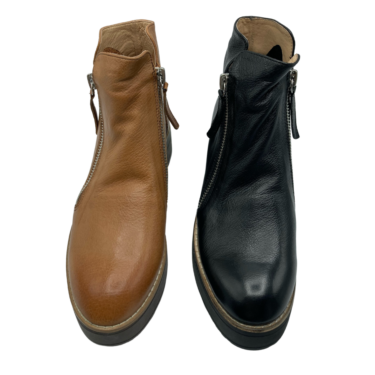 Top view of one cognac leather boot and one black leather boot side by side