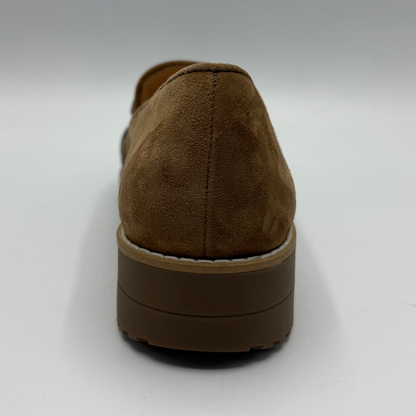 A brown suede loafer shown from a rear three-quarter view, featuring a chunky brown platform sole and white contrast stitching along the edge.