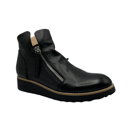 45 degree angled view of black leather short boot with double zipper closure, small wedge outsole and rounded toe