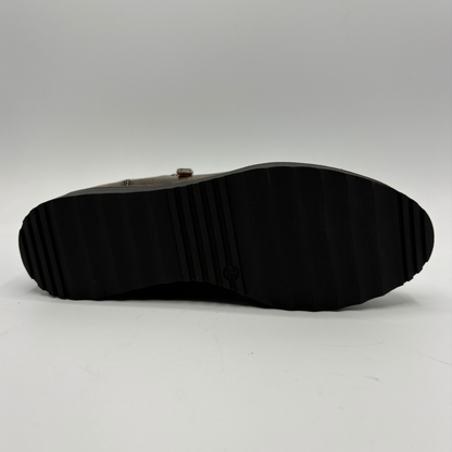 The black rubber outsole of a boot, shown from a top-down perspective against a light gray background.