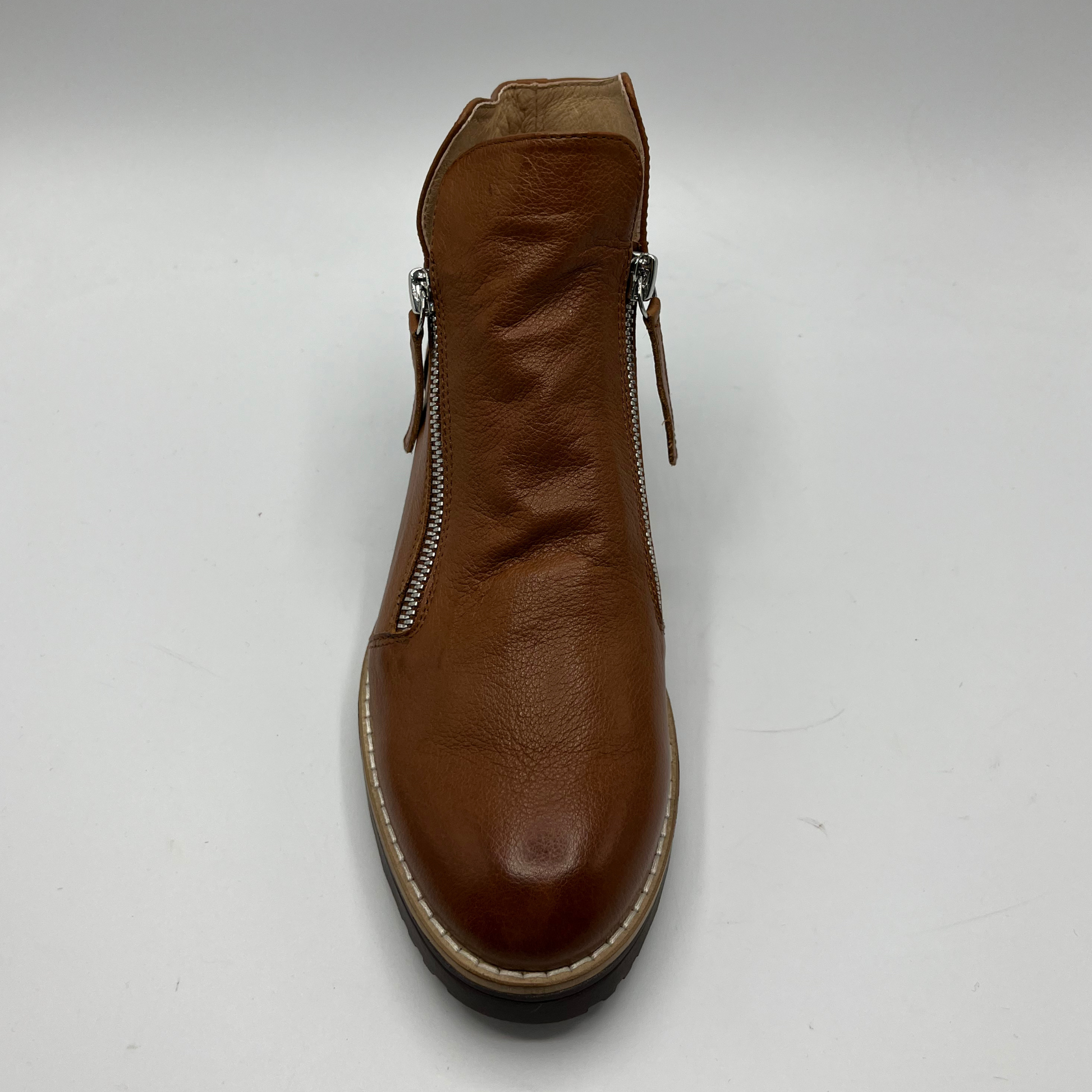 Brown leather boot with a double zipper on a white background