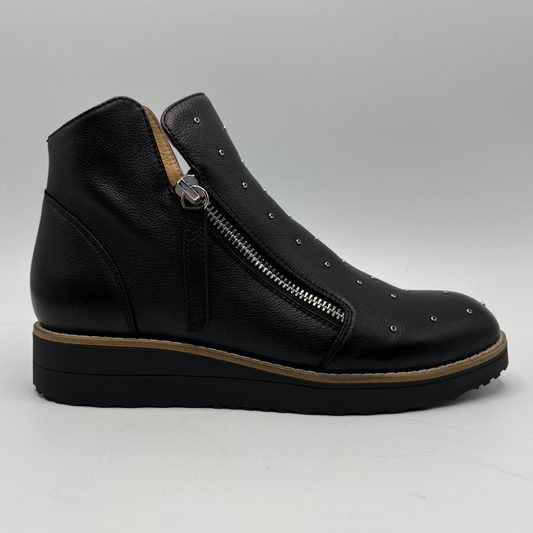 A black leather ankle boot with a side zipper, silver studs, and a brown platform sole, shown from a side profile on a light gray background.
