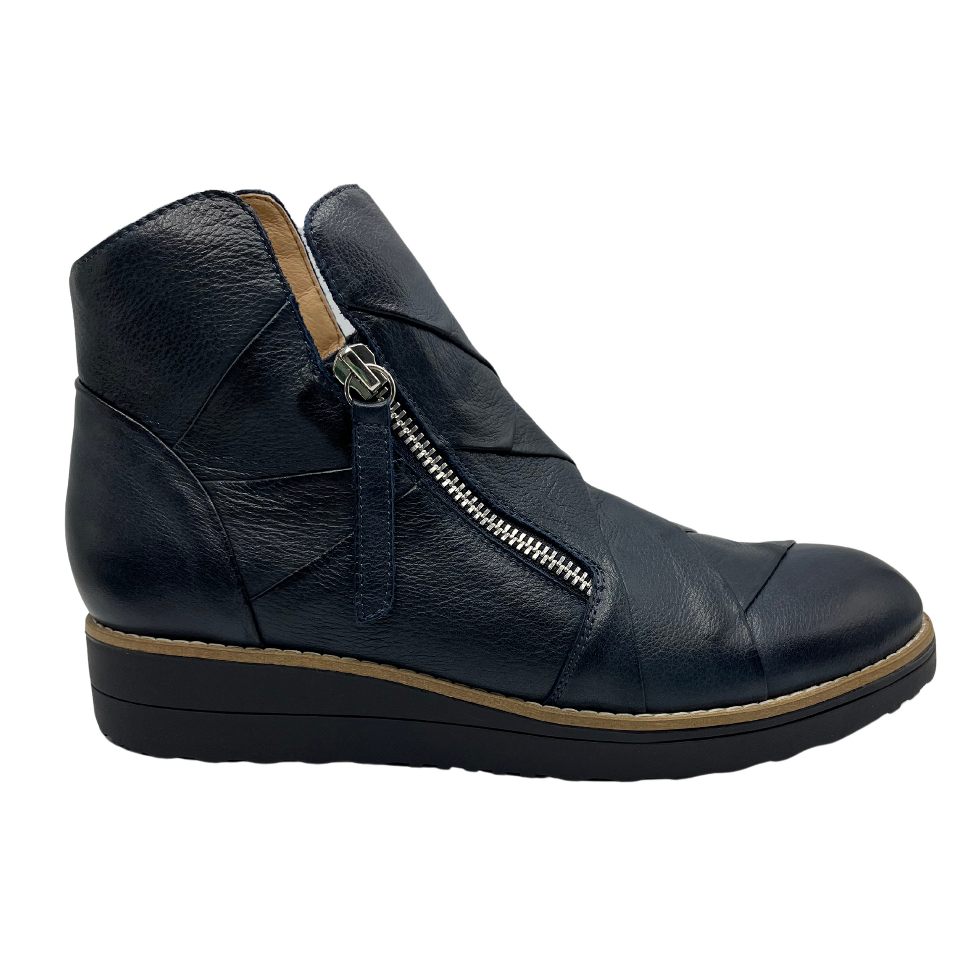 Right facing view of navy leather short boots with weave design on the upper with double zipper closures