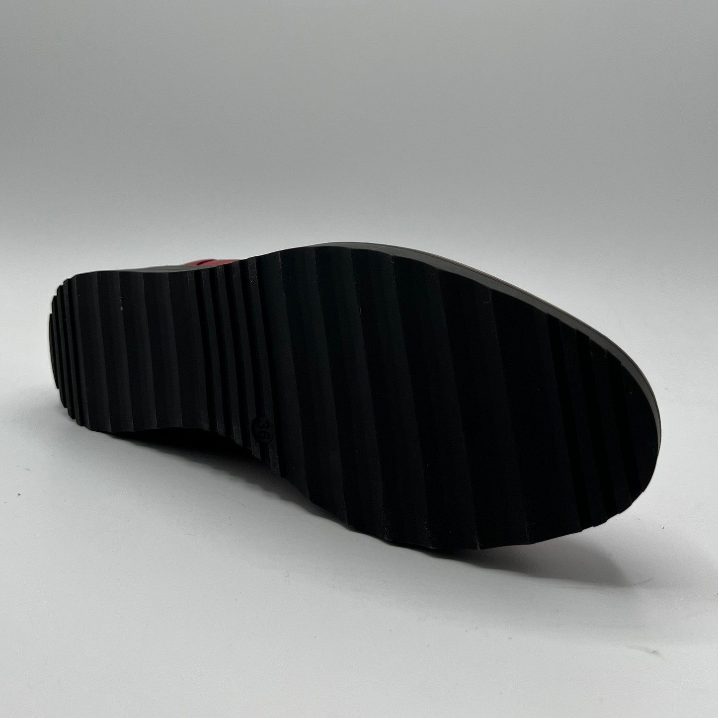 Black sole of a shoe on a gray background