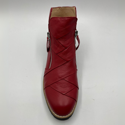 Red leather ankle boot with a braided design on a white background