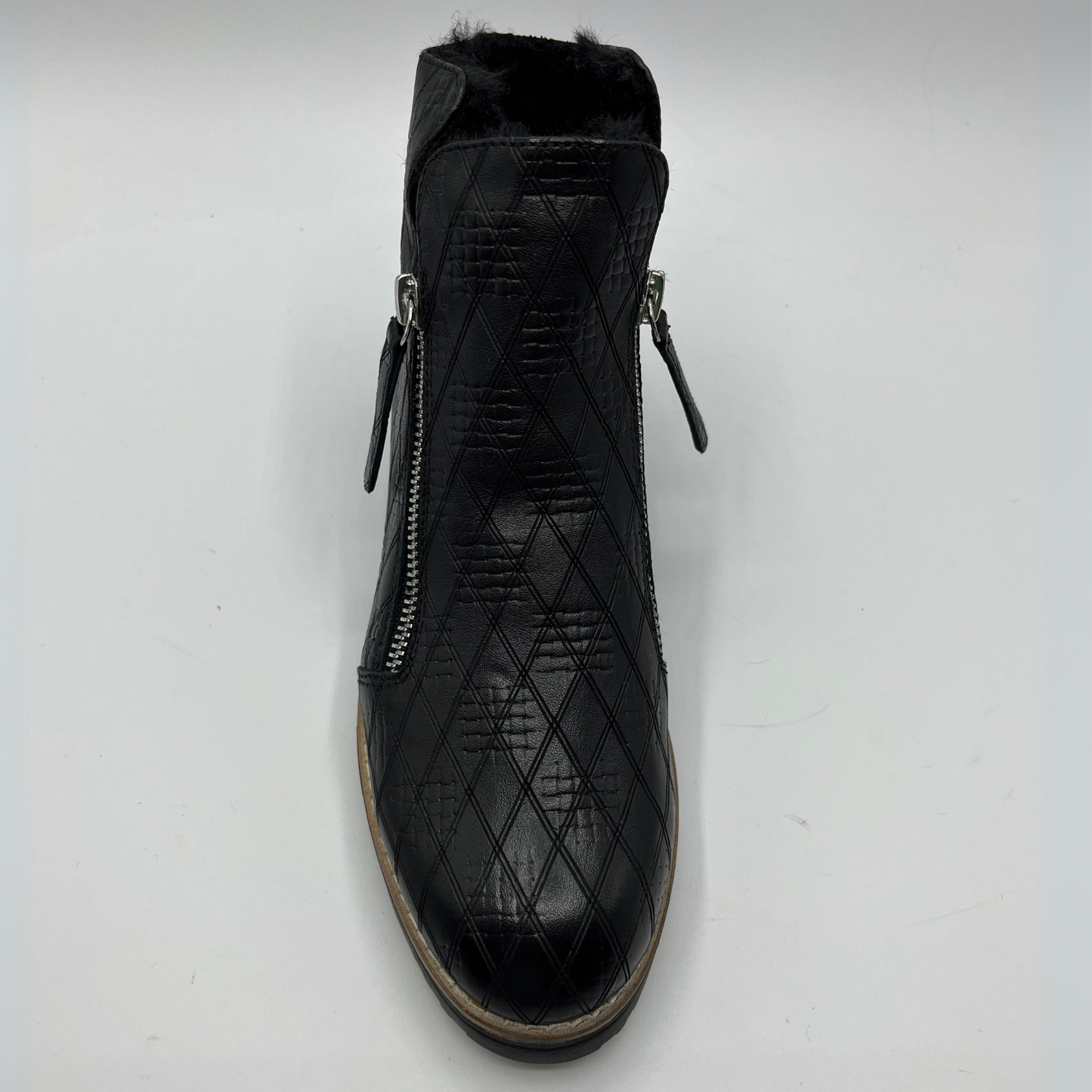 Black quilted ankle boot with zippers on a white background