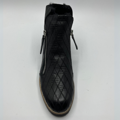 Black quilted ankle boot with zippers on a white background