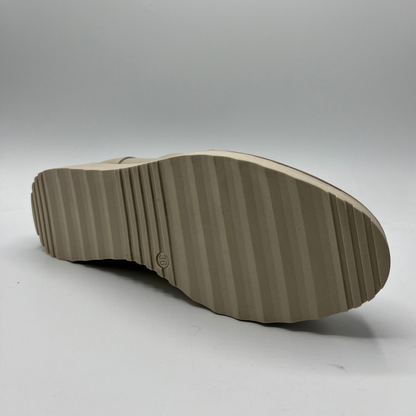 Close-up of a brown shoe sole on a gray background