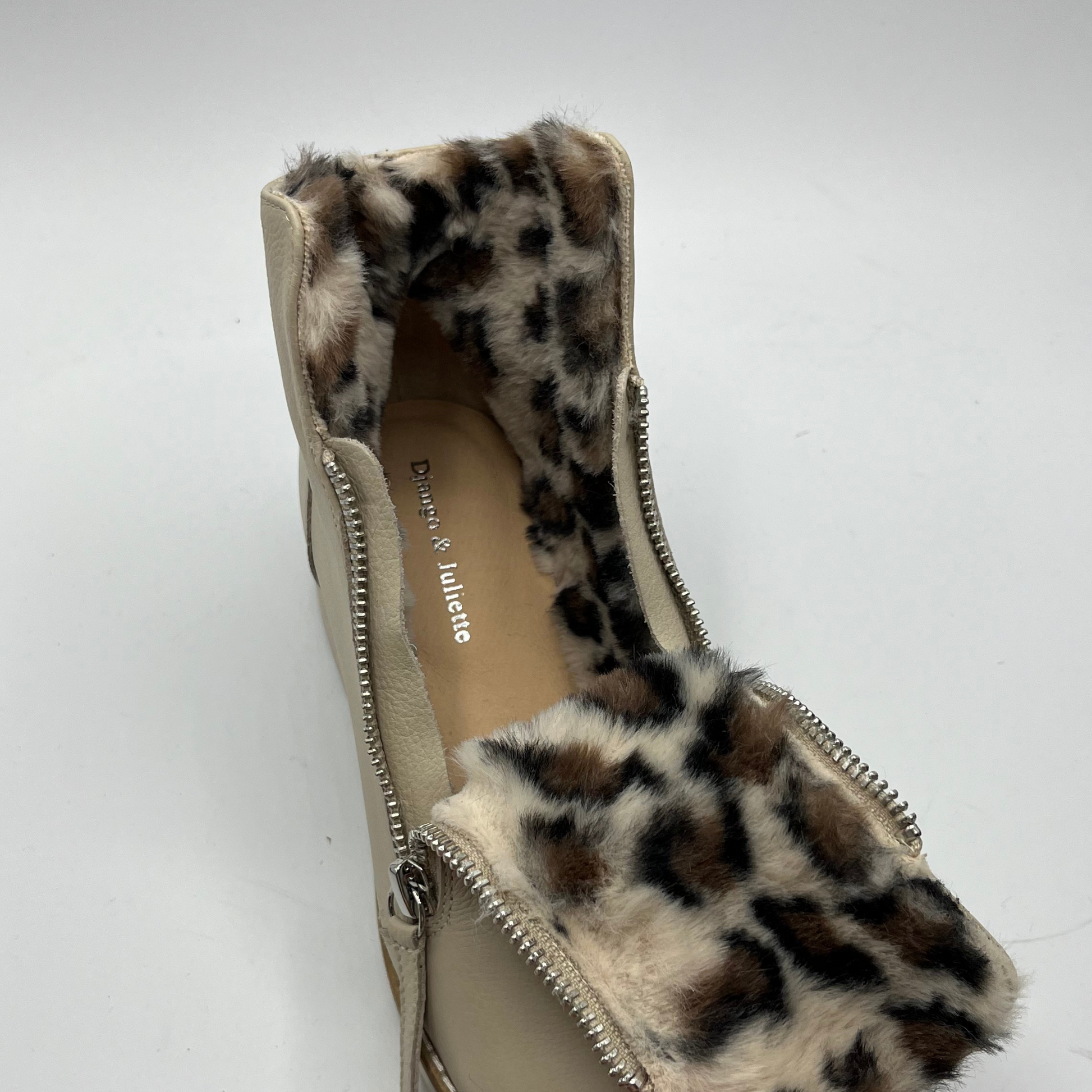 Beige short boot with leopard print faux fur on a white background