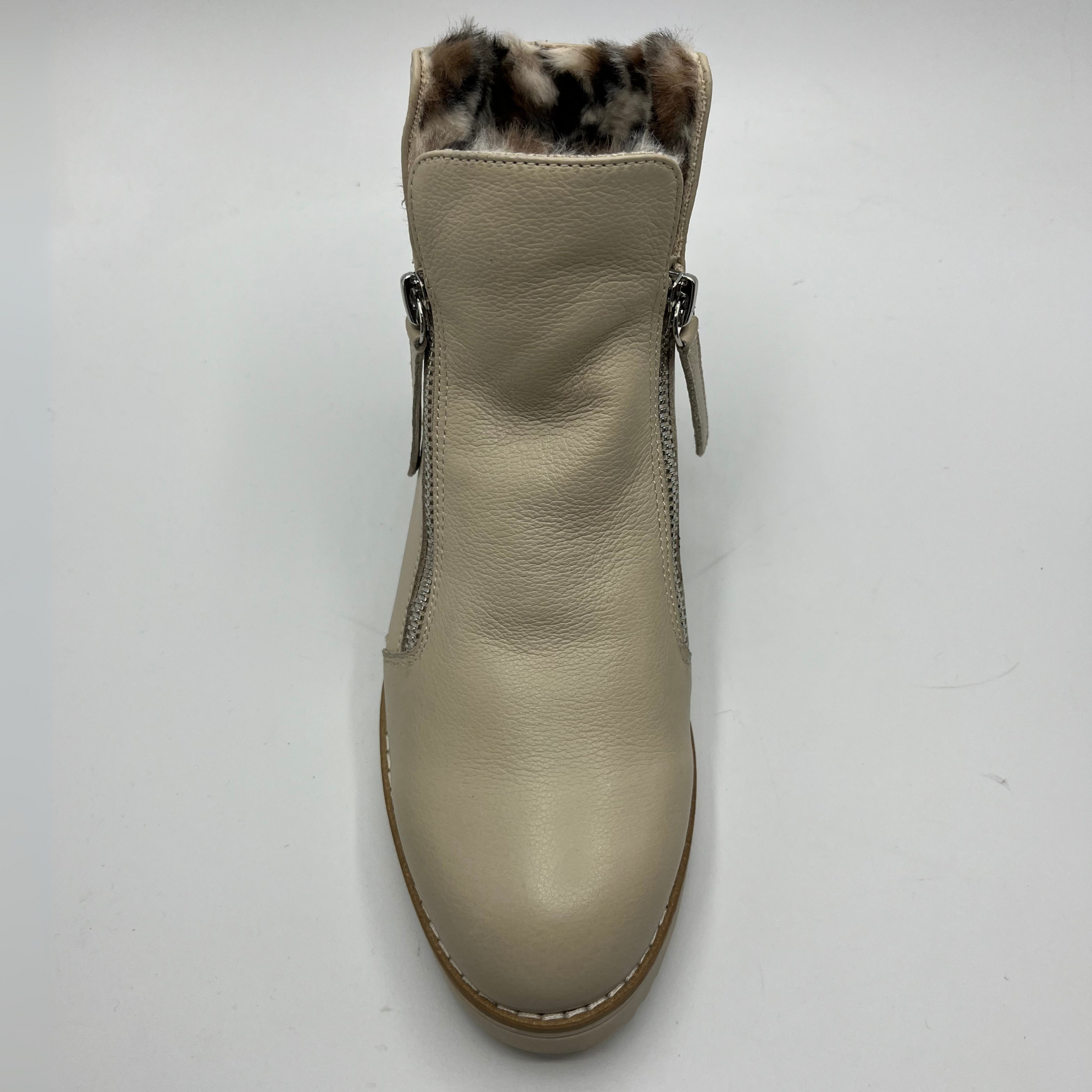 Beige ankle boot with faux fur lining on a white background