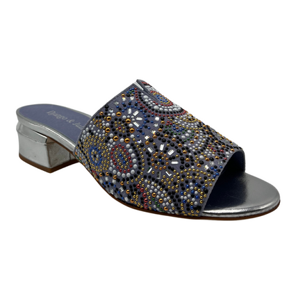 45 degree angled view of denim blue mule sandal with beaded detail on upper