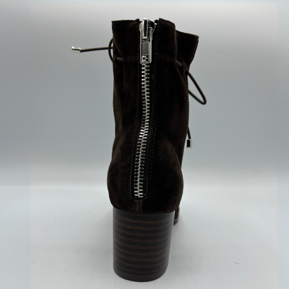 Back view of a chocolate leather with a chocolate patent leather toe cap. Stacked heel and unique tie up ankle