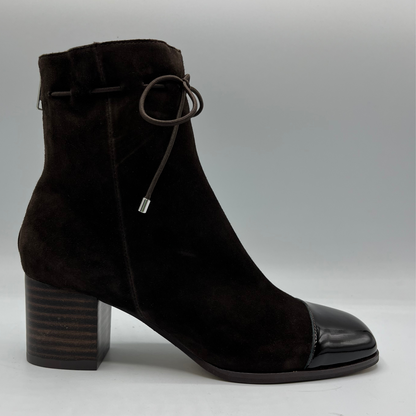 Right facing view of a chocolate leather with a chocolate patent leather toe cap. Stacked heel and unique tie up ankle