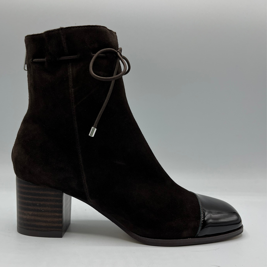 Right facing view of a chocolate leather with a chocolate patent leather toe cap. Stacked heel and unique tie up ankle