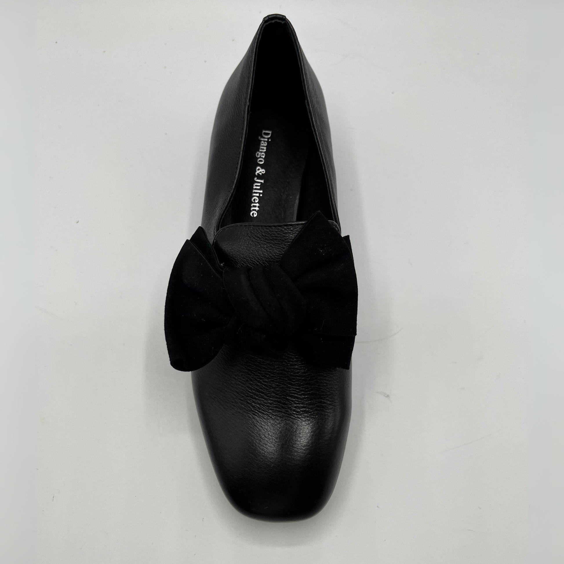 Black shoe with a bow on a white background