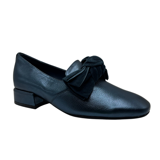 45 degree angled view of metallic blue leather heeled shoes with a velvet knotted bow detail and rounded toe