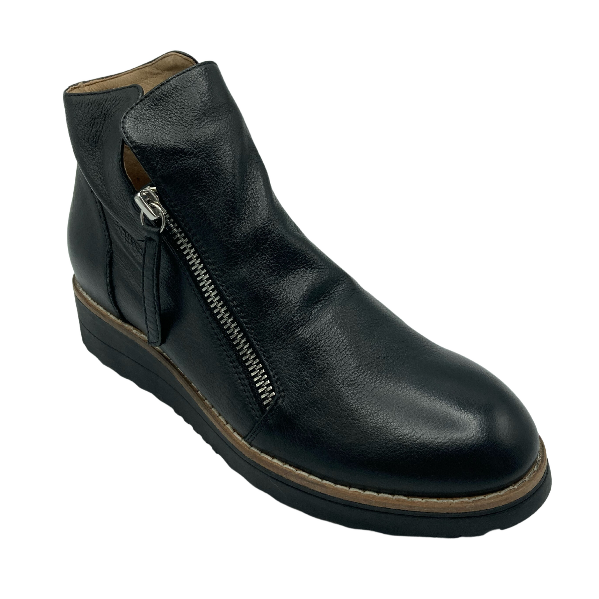 45 degree angled view of short black leather boot with silver zipper and black rubber sole