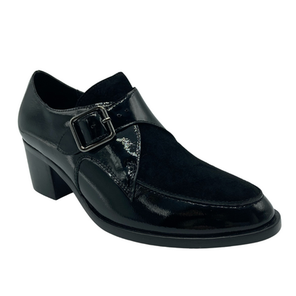 45 degree angled view of black patent and suede leather heeled loafer.