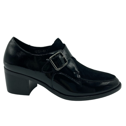 Right facing view of black leather loafer with silver buckle detail, block heel and pointed toe
