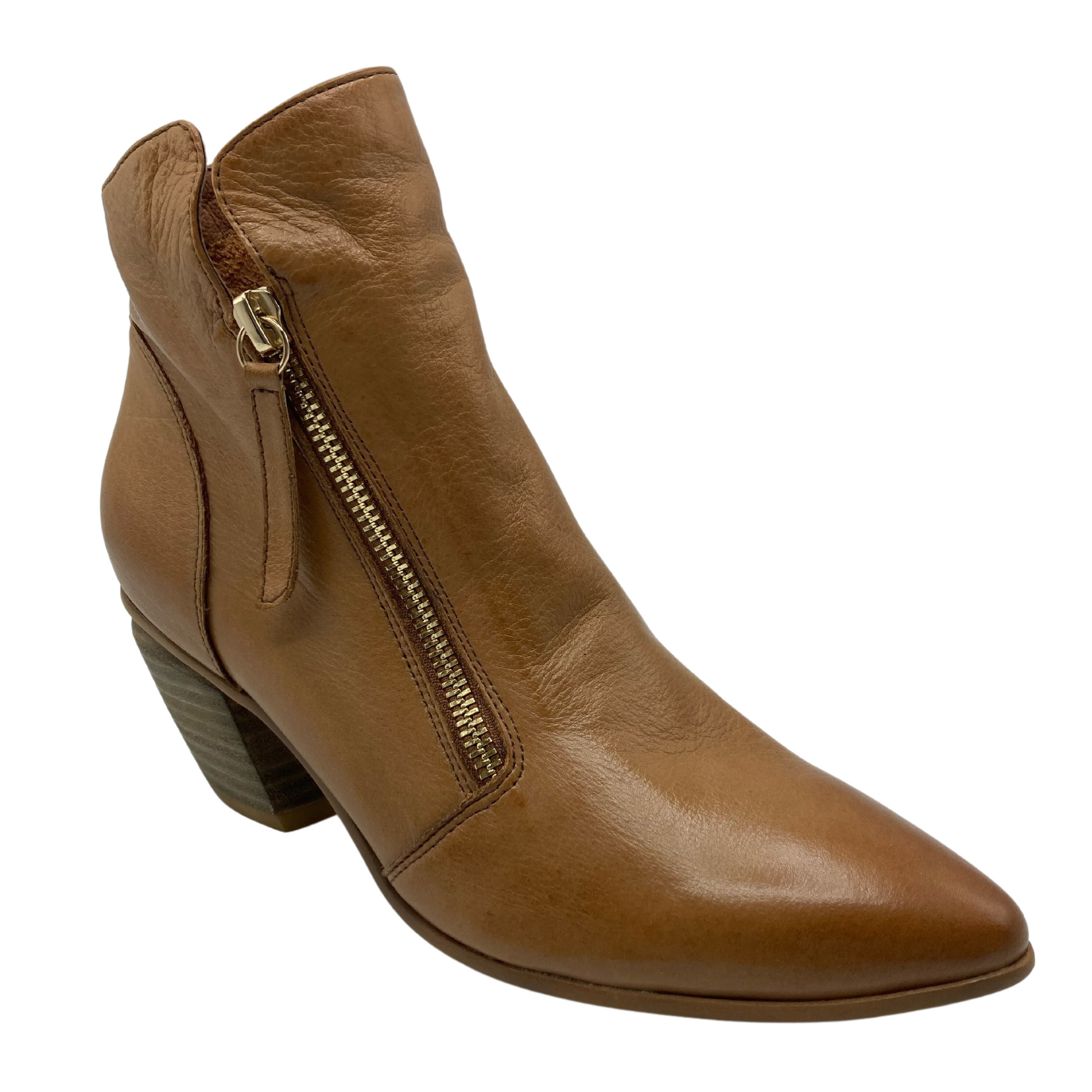 45 degree angled view of leather short boot with gold zipper detail and pointed toe
