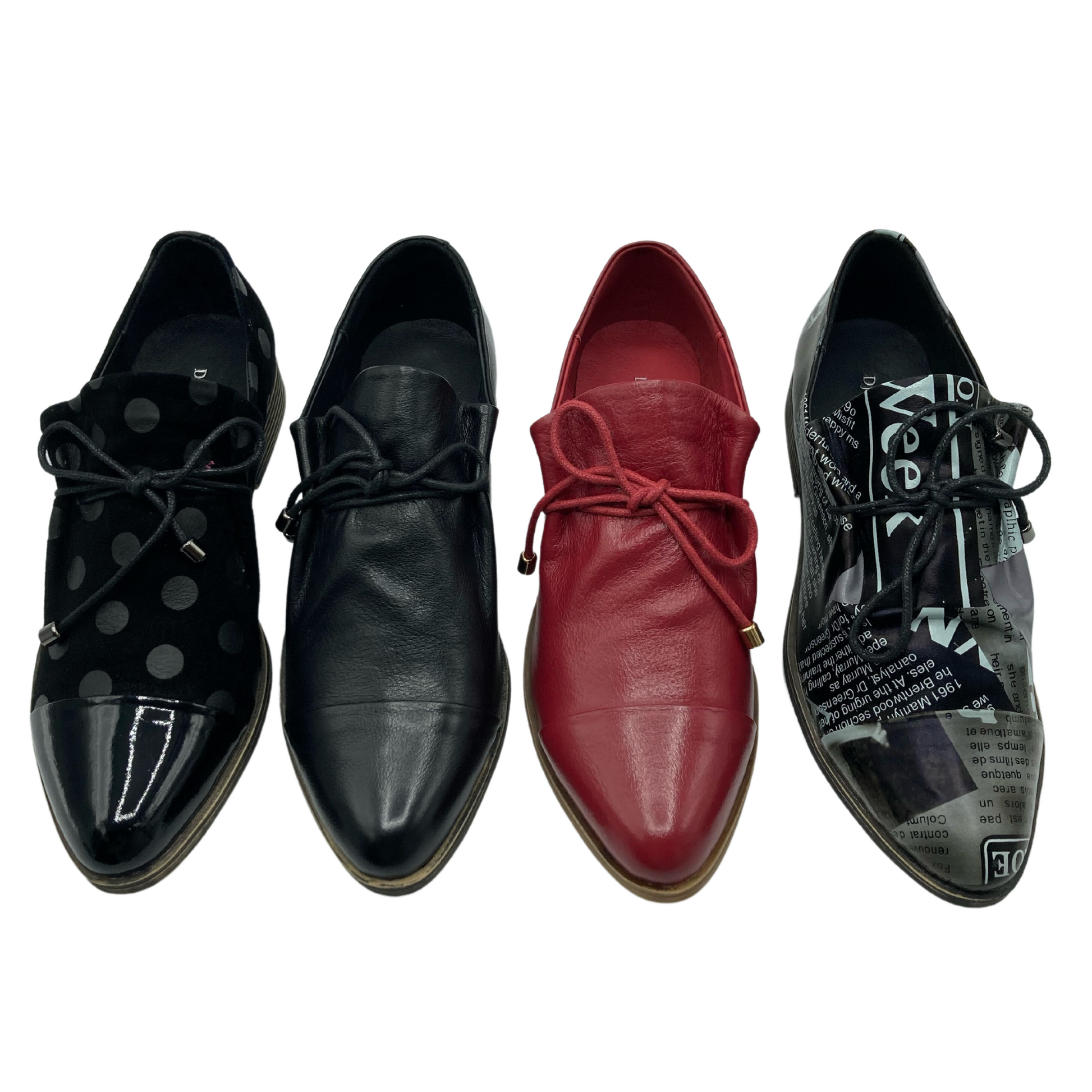 View of 4 shoes side by side. Far left is black with shiny black polka-dots and toe cap, next is all black, second from the right is red and far right is a grey and black newspaper print