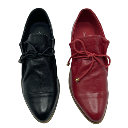 A black shoe and a red shoe side by side. Both have coordinating laces and a soft pointed toe