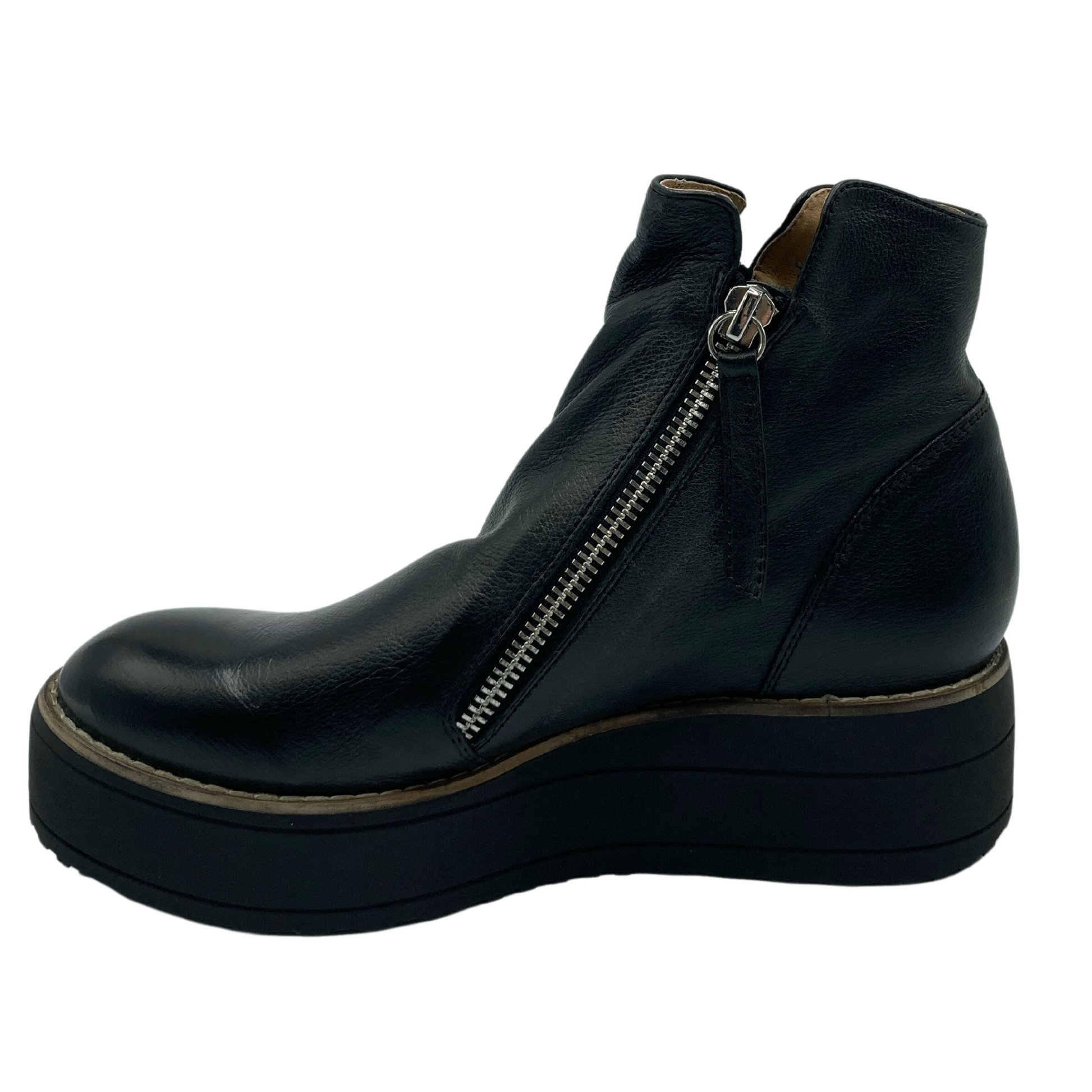 Left facing profile view of black platform short boot with leather upper and silver angled zipper