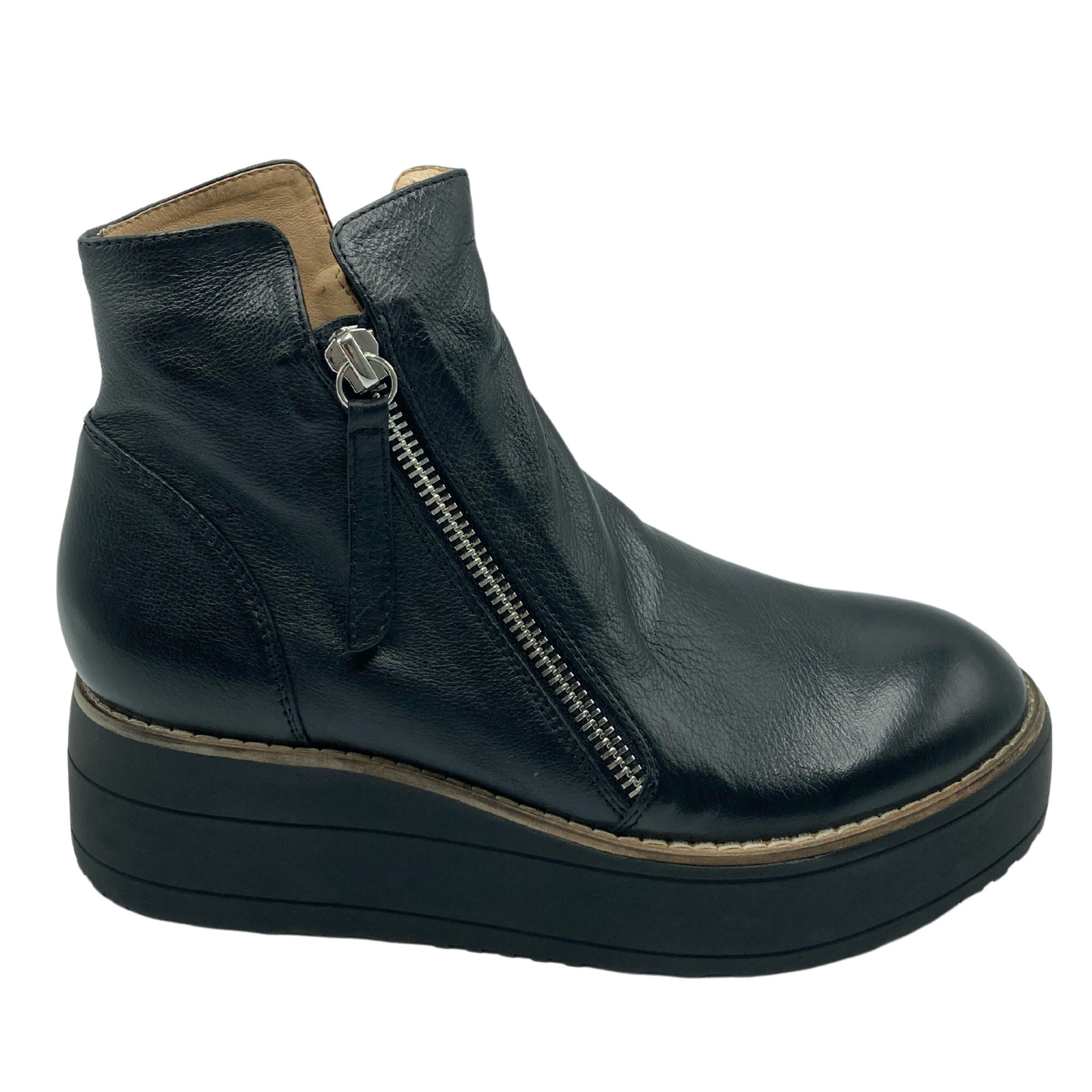 Right facing profile view of black leather wedge short boot with angled silver zipper