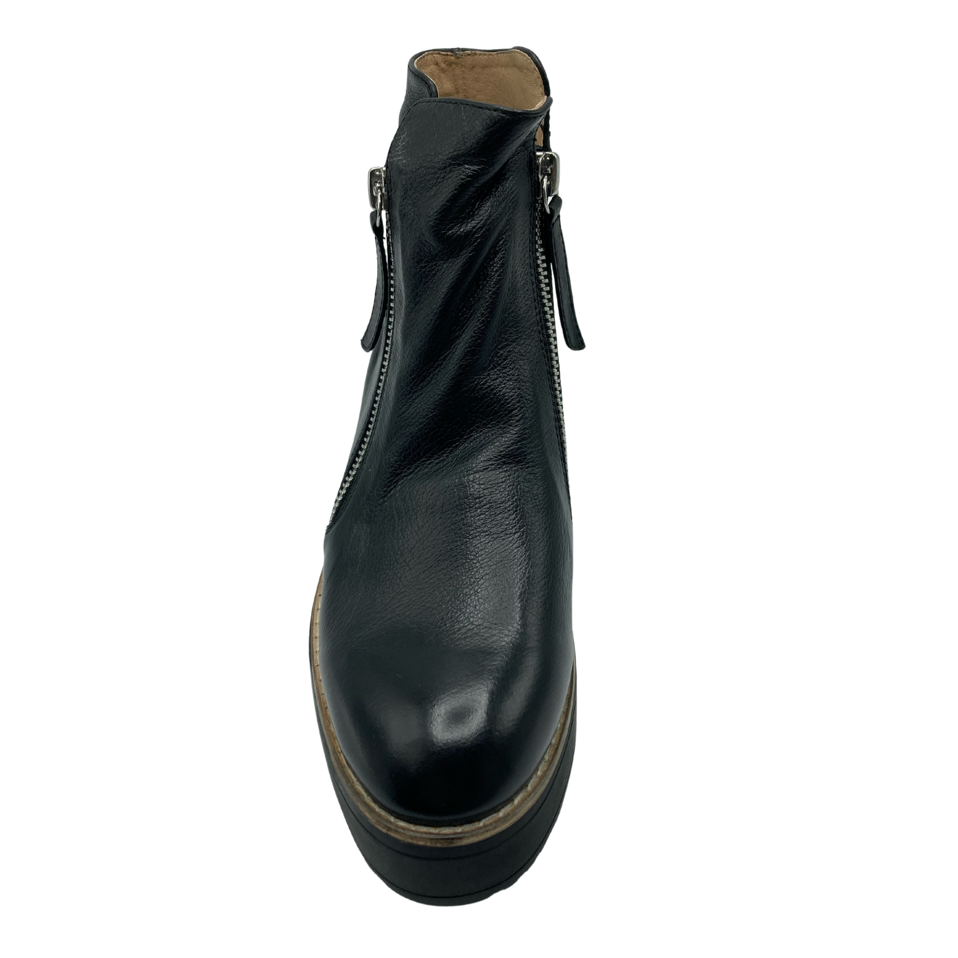 Top view of black leather short boot with rounded a zipper on the inside and outside of ankle