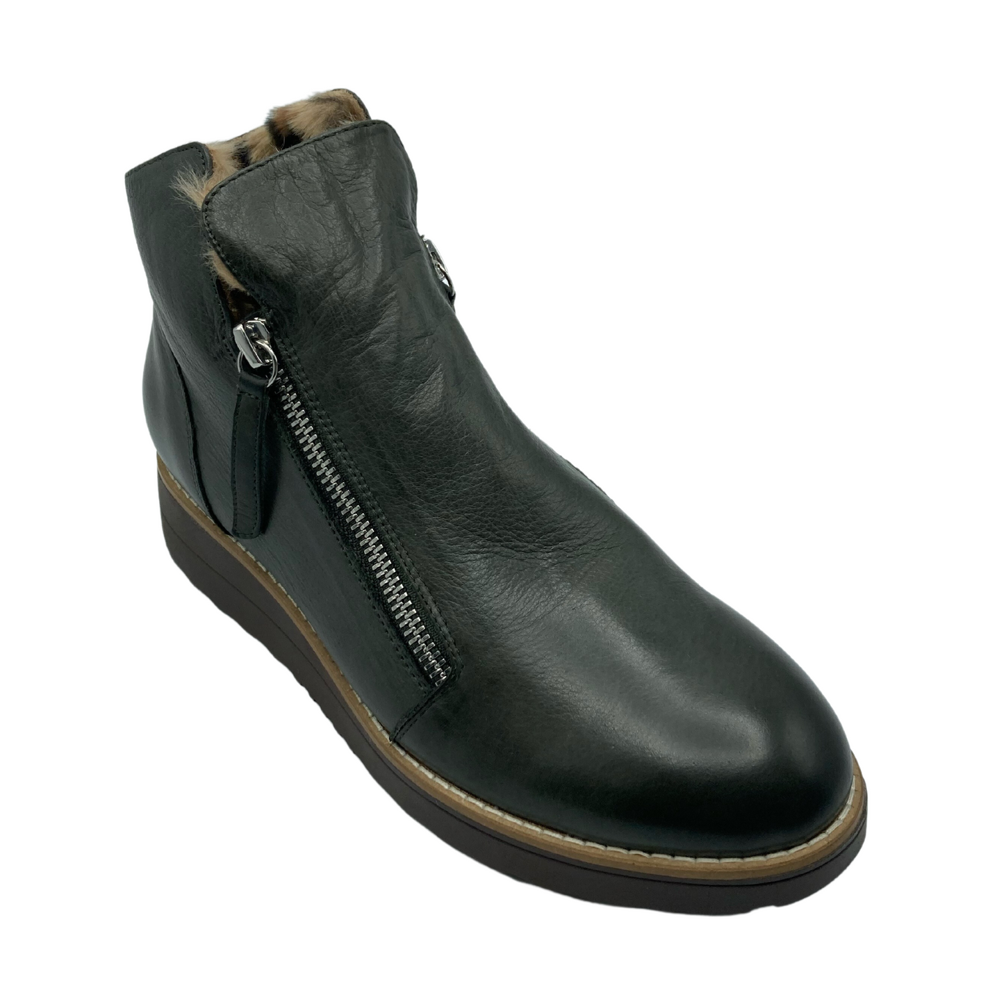 45 degree angled view of dark green leather boot with double zipper closure and rounded toe