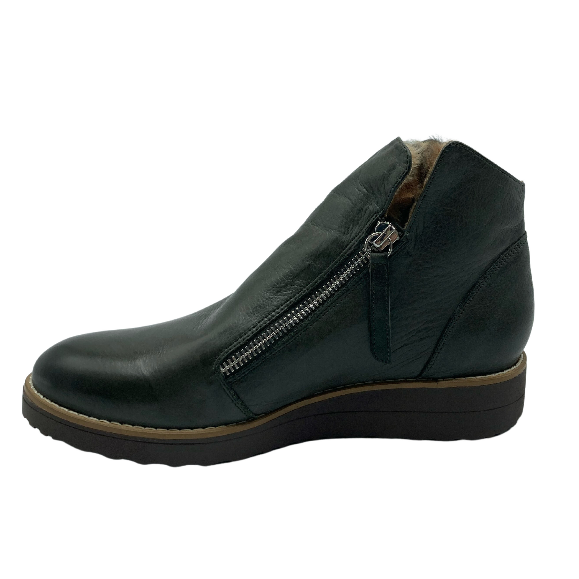Left facing view of olive green ankle boot with silver zipper closure and brown rubber sole