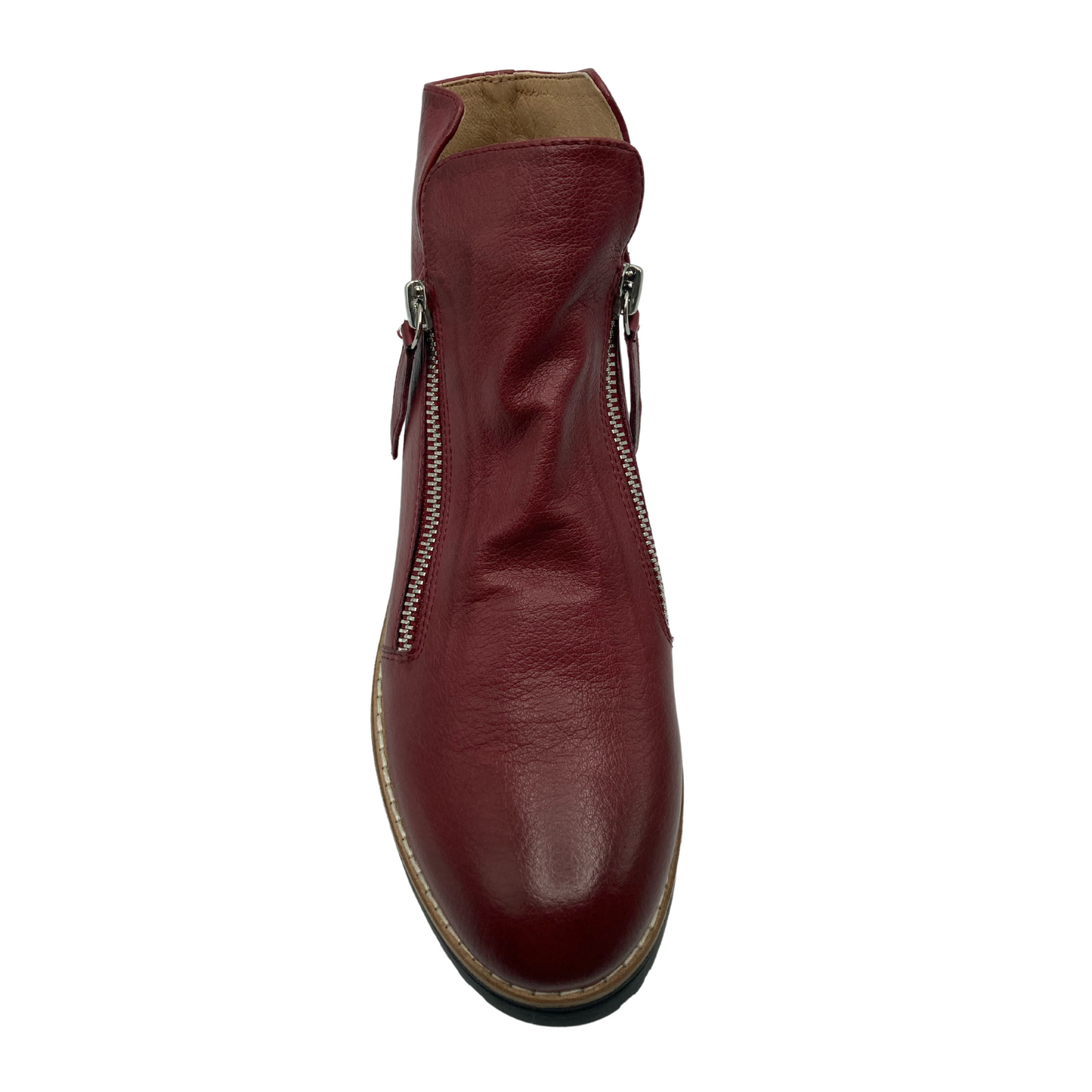 Top view of red leather boot with rounded toe and a zipper on either side of the ankle