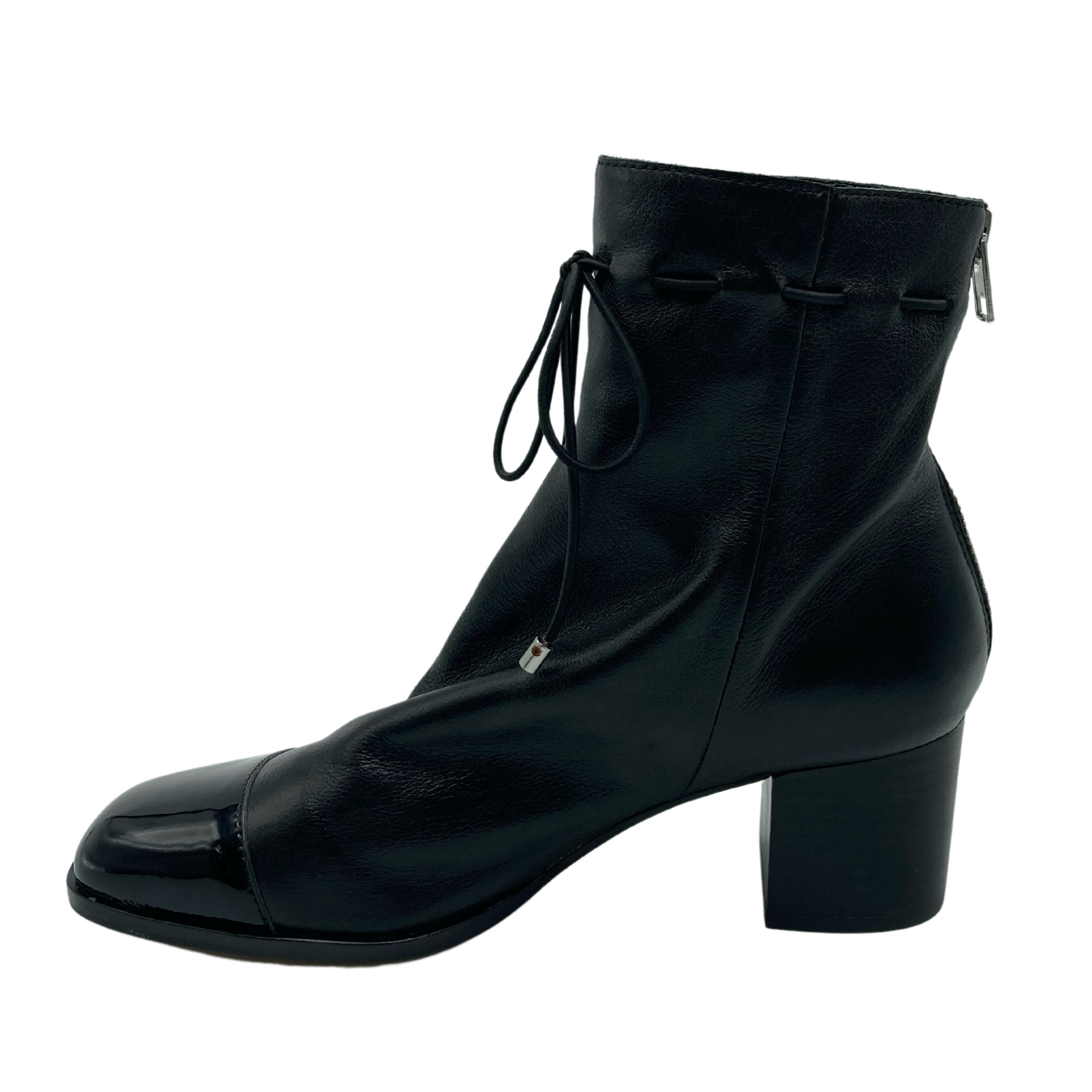 Left facing view of black leather ankle boot with zipper closure and thin ankle tie.