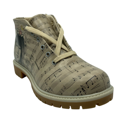 45 degree angled view of vegan leather ankle boot with sheet music pattern with an image of a woman on the outer ankle