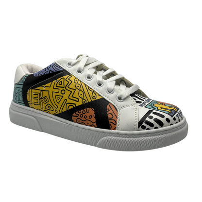 Angled view of a sneaker with a white base and colourful artwork all around the upper of the shoe. Padded white collar, white laces and white rubber outsole.