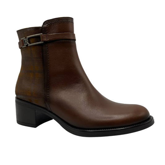 45 degree angled view of brown leather short boot with decorative ankle strap, short block heel and printed pattern on the ankle