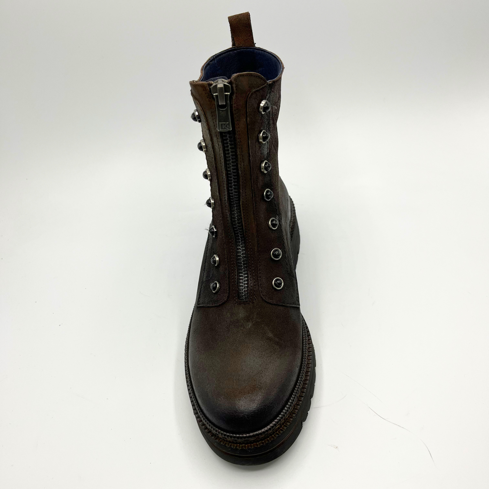 Brown leather boot with multiple zippers on a white background