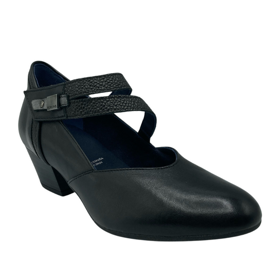 45 degree angled view of a black leather pump with short block heel and double velcro strap