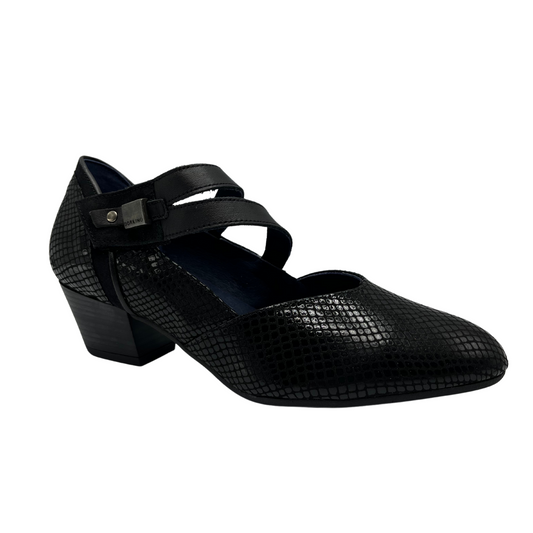 45 degree angled view of black leather pump with a shiny scale like pattern on the upper. Sturdy stacked heel, slightly pointed toe and double velcro strap.