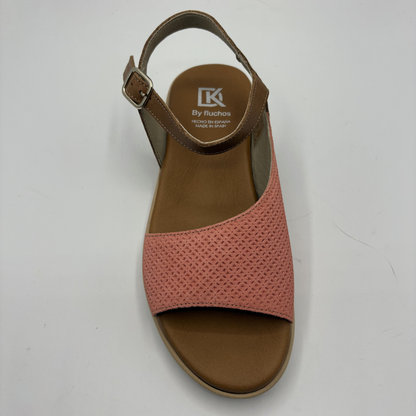 Pink sandal with brown sole on a white background