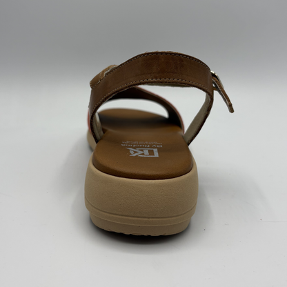 Brown sandal with a platform sole on a white background