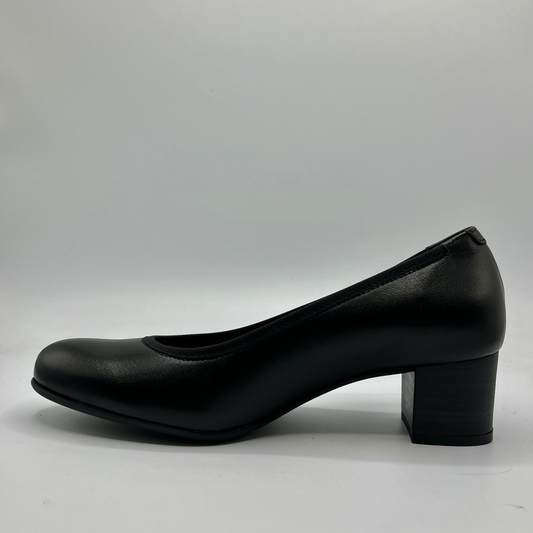 Black shoe with a block heel on a gray background