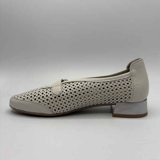 Beige shoe with perforated design on a gray background
