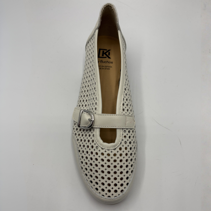 White perforated shoe with a buckle on a white background