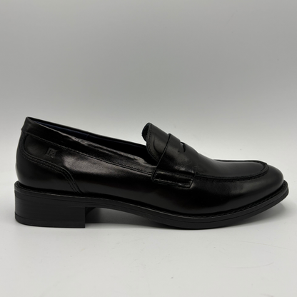 A single black leather penny loafer shoe with a low block heel, shown in a side profile view against a neutral gray background.