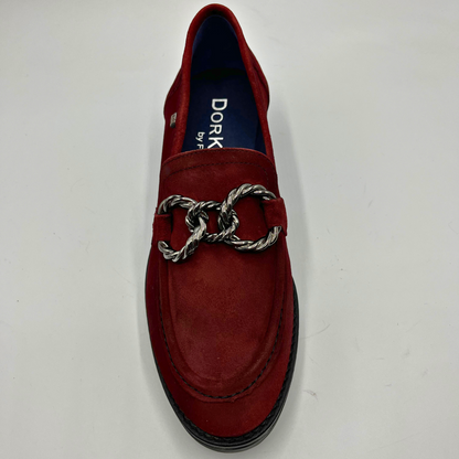 Red loafer shoe with a silver chain detail on a white background