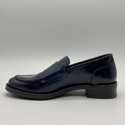 Left facing view of a blue leather loafer with two silver buckles