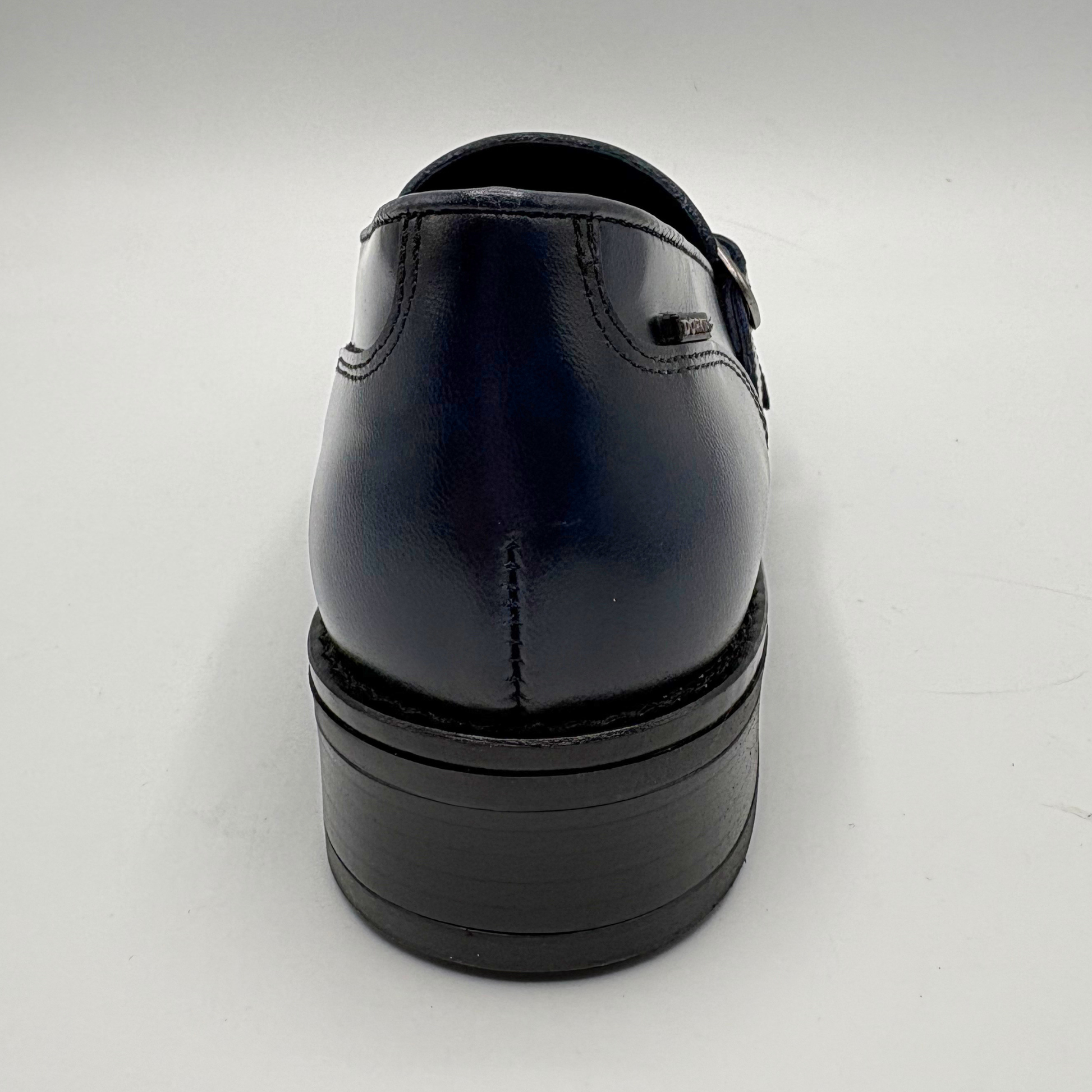 Back view of a blue leather loafer with two silver buckles