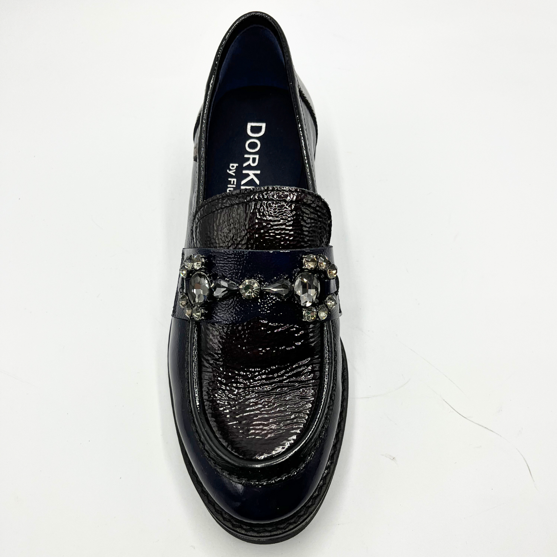 Navy loafer shoe with decorative elements on a white background